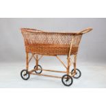 AN EARLY 20TH CENTURY WICKER BASSINET