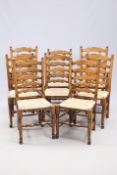 A SET OF EIGHT OAK AND RUSH SEATED LADDERBACK DINING CHAIRS