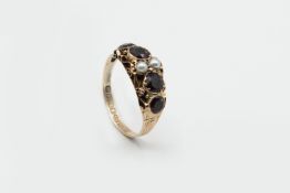 A LATE GEORGIAN GARNET AND SEED PEARL RING