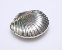 A LATE 19TH CENTURY SILVER-PLATED SHELL SHAPED VESTA CASE