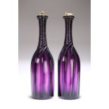 A PAIR OF 19TH CENTURY AMETHYST GLASS BOTTLE DECANTERS
