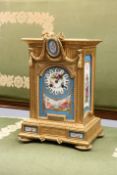 A FRENCH GILT-METAL AND PORCELAIN MOUNTED MANTEL CLOCK