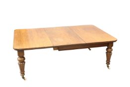 A VICTORIAN MAHOGANY EXTENDING DINING TABLE