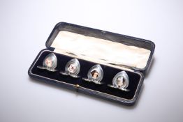 A SET OF FOUR EDWARD VII SILVER AND ENAMEL PLACE CARD HOLDERS, BY SAMPSON MORDAN AND CO., CHESTER, 1