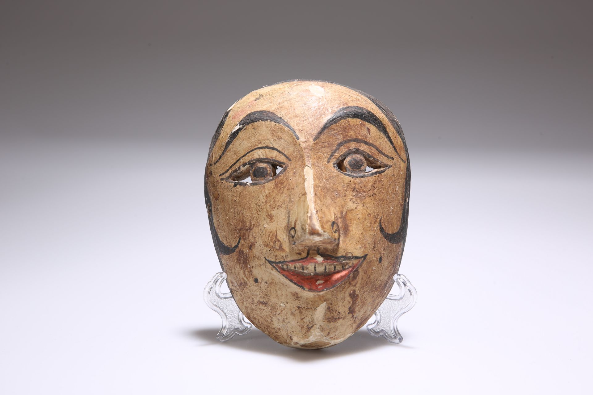 A CARVED AND PAINTED WOODEN RITUAL MASK