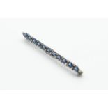 A DIAMOND AND SAPPHIRE BAR BROOCH