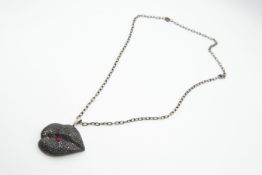 A BLACK DIAMOND AND RUBY "LIPS" PENDANT BY GAVELLO