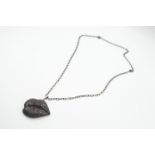 A BLACK DIAMOND AND RUBY "LIPS" PENDANT BY GAVELLO