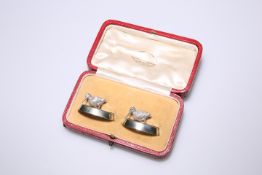 A PAIR OF EDWARD VII SILVER PLACE-CARD HOLDERS, BY WILLIAM HORNBY, LONDON, 1908