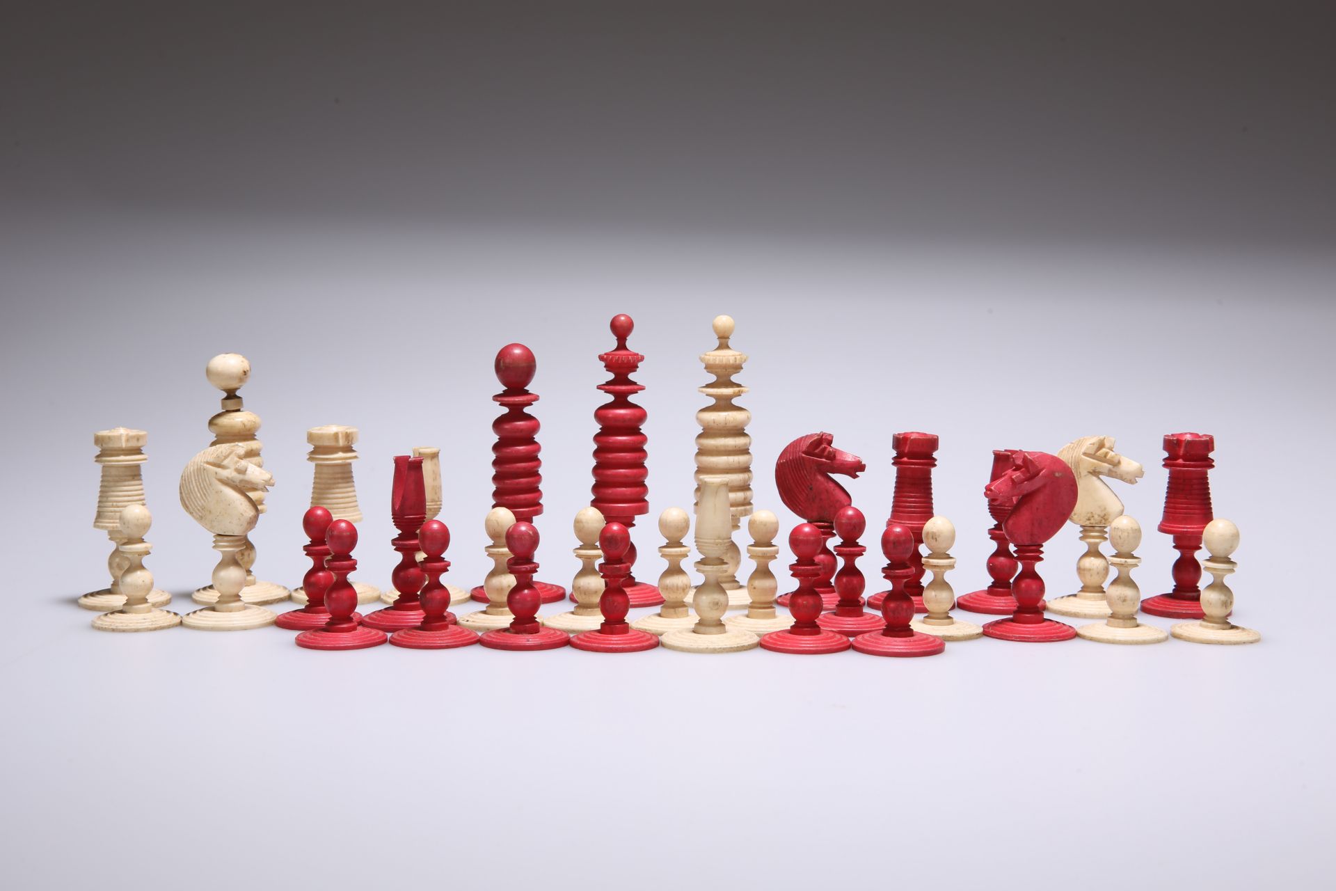 A 19TH CENTURY STAINED AND NATURAL BONE CHESS SET