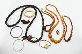 A COLLECTION OF THREE AMBER COLOURED BEAD NECKLACES
