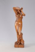 A FINE AND LARGE CARVED OAK FIGURE OF A SCANTILY CLAD MAIDEN