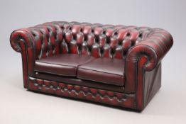 AN OX BLOOD LEATHER THREE-PIECE CHESTERFIELD SUITE