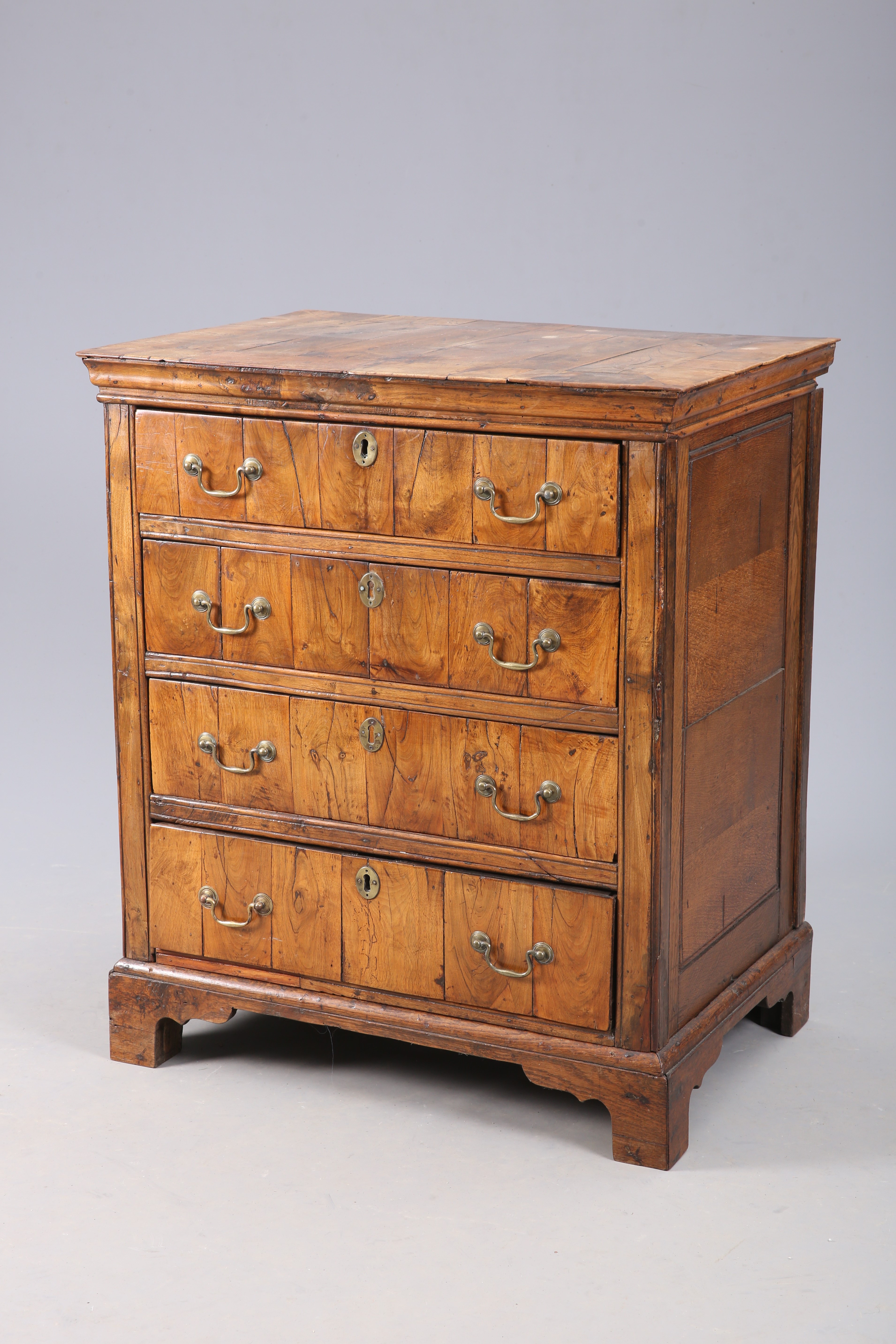 A SMALL WALNUT CHEST OF DRAWERS