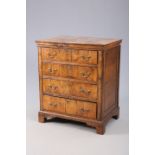 A SMALL WALNUT CHEST OF DRAWERS