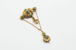 A GILT METAL AND TURQUOISE SET BROOCH