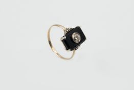 A BLACK ONYX AND DIAMOND RING