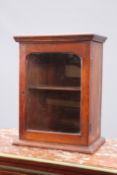 A SMALL MAHOGANY GLAZED CABINET