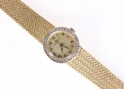 A BAUME & MERCIER GOLD AND DIAMOND WRIST WATCH