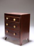 A MINIATURE MAHOGANY CHEST OF DRAWERS IN THE REGENCY TASTE