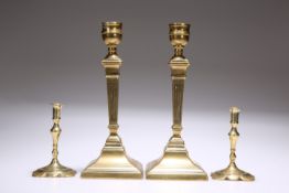 TWO PAIRS OF BRASS CANDLESTICKS