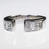 AN 18CT WHITE GOLD AND DIAMOND SET TORQUE STYLE RING