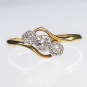 AN 18CT YELLOW GOLD AND PLATINUM DIAMOND SET CROSSOVER RING