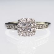 A 9CT WHITE GOLD AND BRILLIANT CUT DIAMOND CLUSTER RING