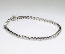 AN 18CT WHITE GOLD AND DIAMOND LINE BRACELET