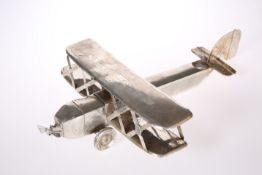 AN EARLY 20TH CENTURY SILVER TWO-SECTION MODEL OF A BIPLANE