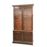 AN EARLY 19TH CENTURY MAHOGANY AND PARCEL-GILT BOOKCASE CABINET