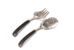 A WHITE METAL SERVING SPOON AND FORK, PROBABLY MALAYSIAN