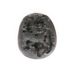 A CHINESE CARVED BLACK ONYX PENDANT