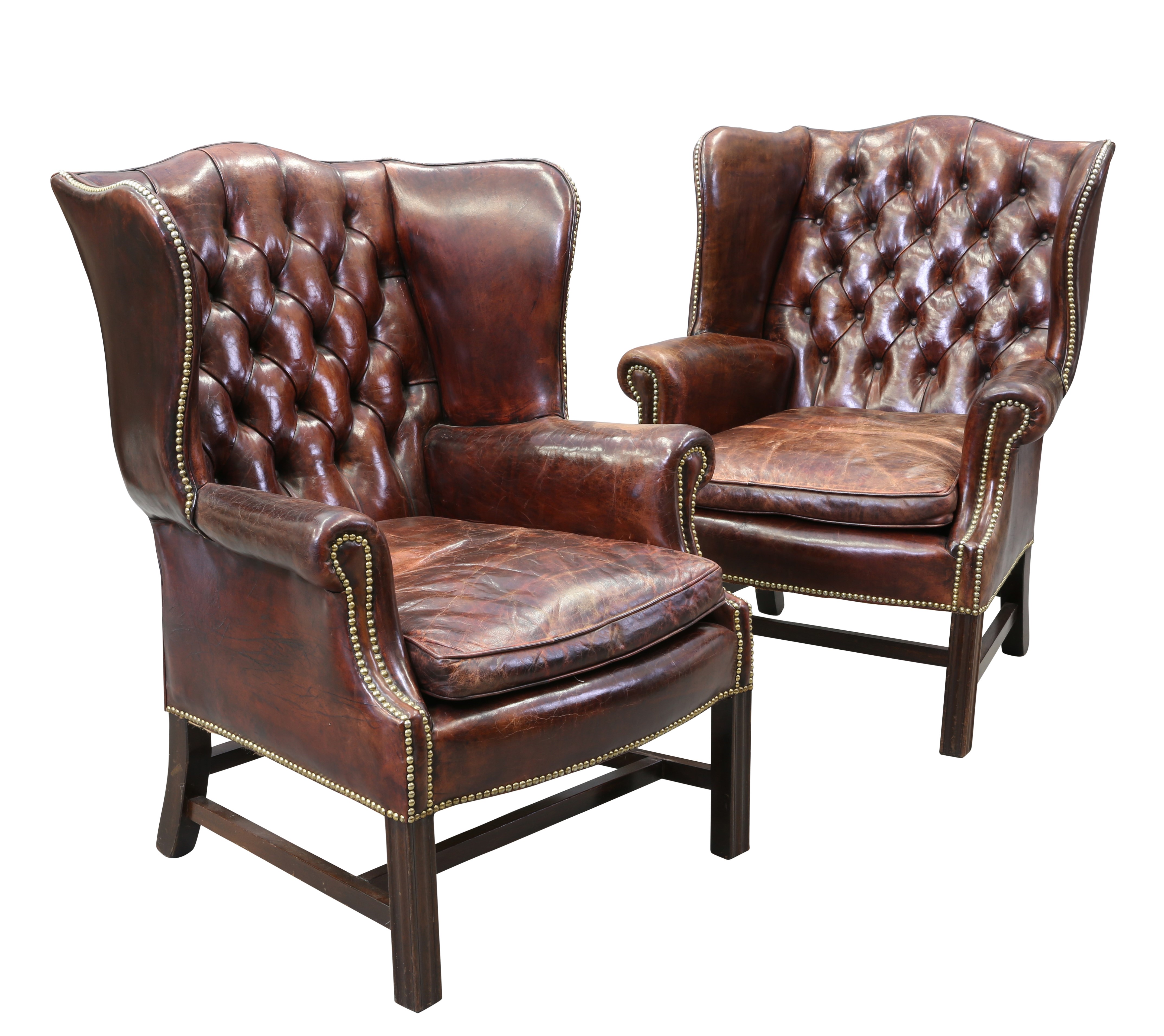 A PAIR OF GEORGIAN STYLE LEATHER WING CHAIRS