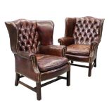 A PAIR OF GEORGIAN STYLE LEATHER WING CHAIRS