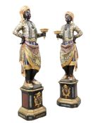 A PAIR OF ITALIAN POLYCHROME CARVED WOODEN TORCHERE FIGURES