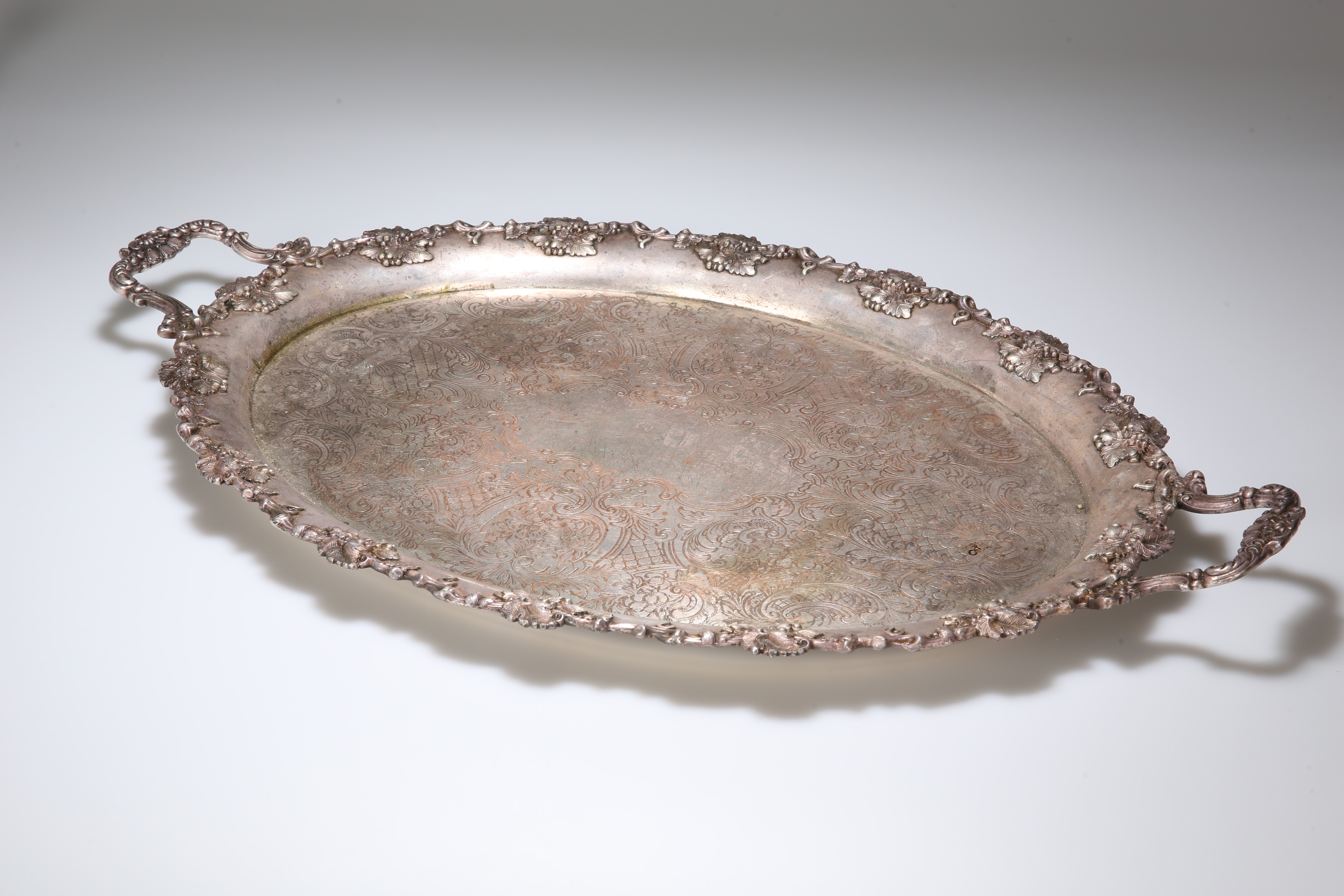 A LARGE LATE VICTORIAN SILVER-PLATED TWO-HANDLED TRAY