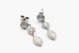 A PAIR OF DIAMOND SET EARRINGS