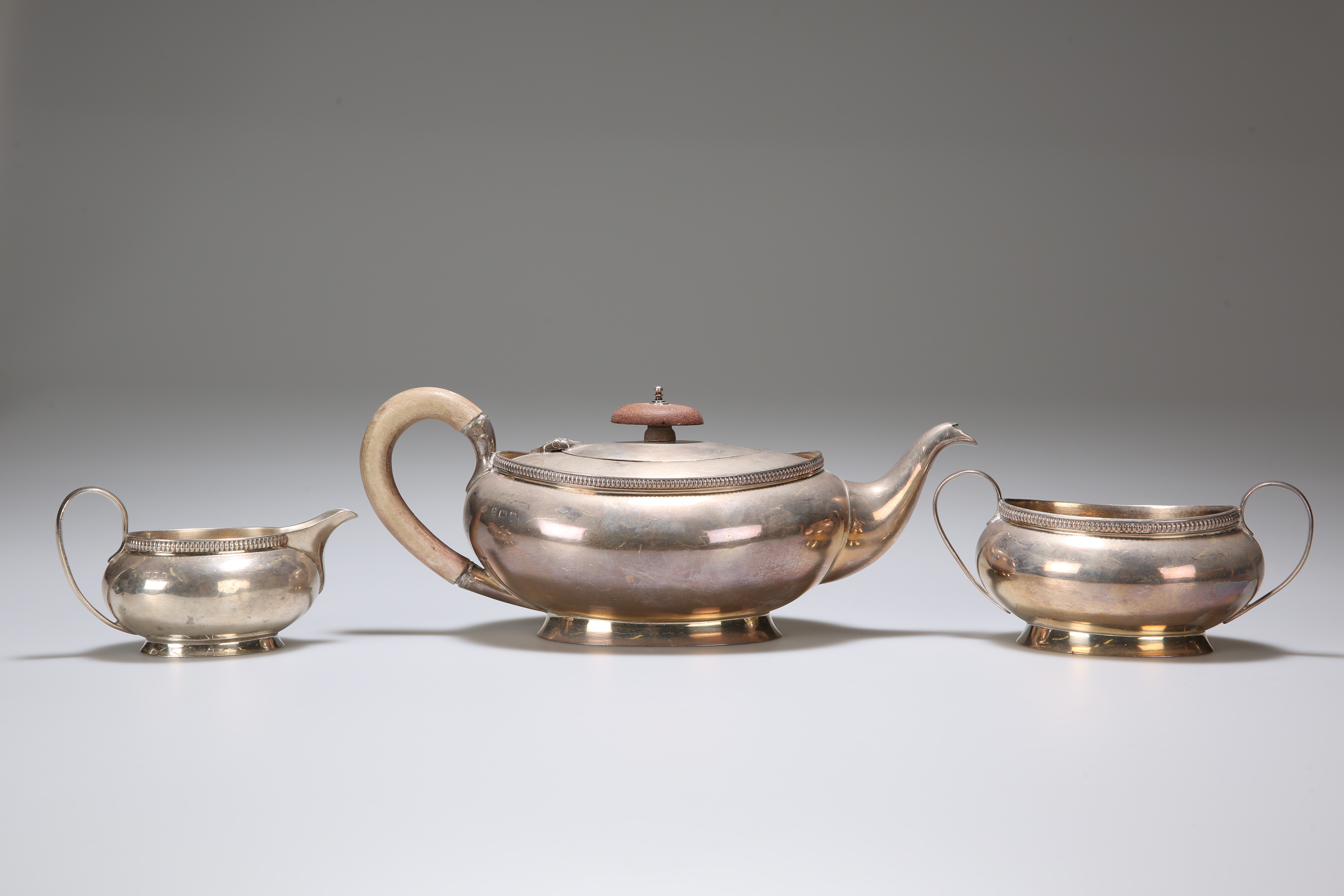 A GEORGE V SILVER THREE-PIECE TEA SERVICE, ADIE BROTHERS