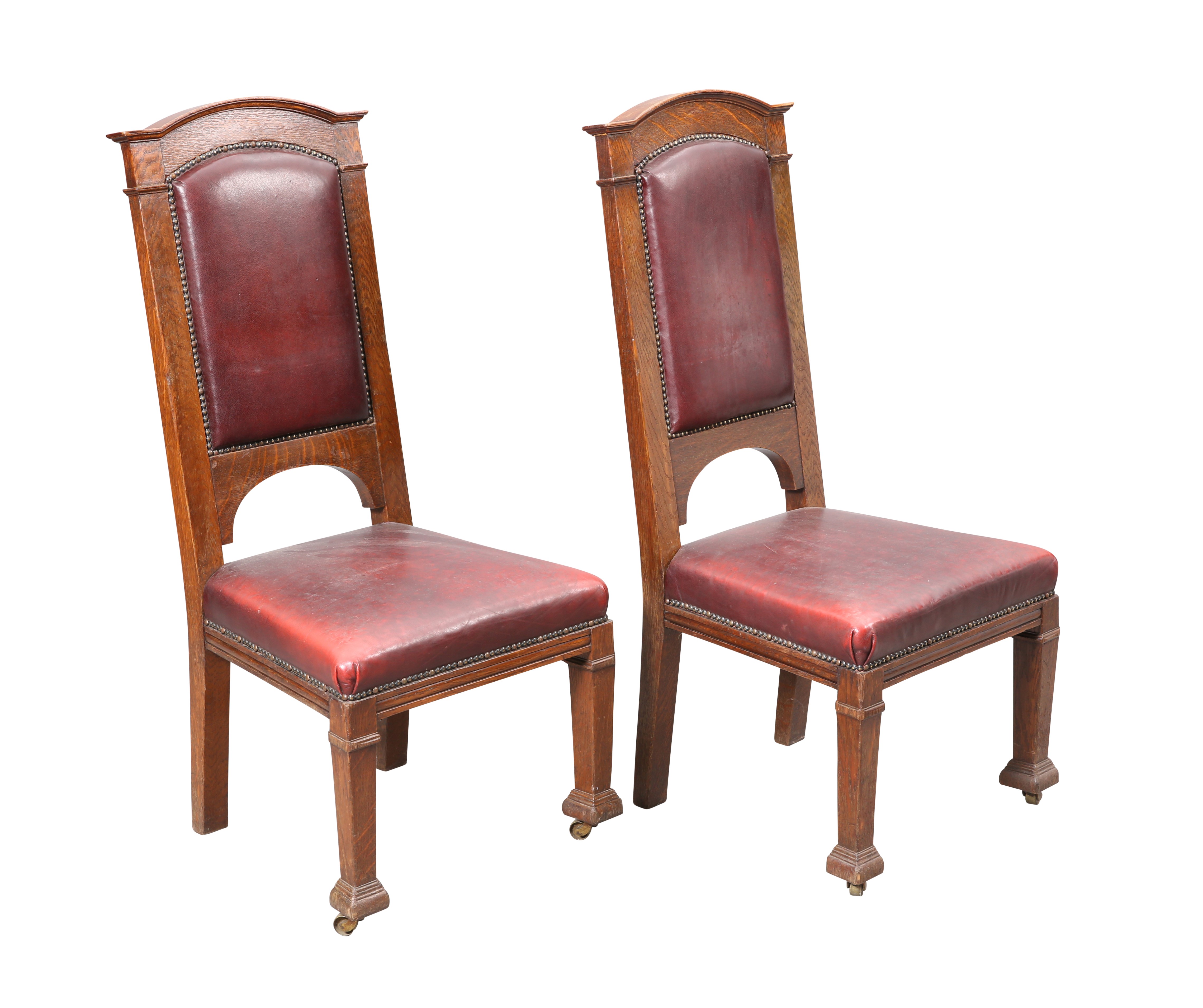 A PAIR OF GLASGOW SCHOOL OAK AND LEATHER HALL CHAIRS