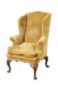 A GEORGE I STYLE WALNUT WING CHAIR