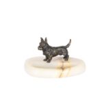 A PATINATED BRONZE MODEL OF A TERRIER MOUNTED ON AN ONYX ASHTRAY