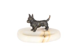 A PATINATED BRONZE MODEL OF A TERRIER MOUNTED ON AN ONYX ASHTRAY