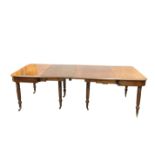 A REGENCY MAHOGANY TELESCOPIC ACTION DINING TABLE, IN THE MANNER OF GILLOWS