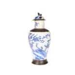 A CHINESE CRACKLE GLAZED BLUE AND WHITE VASE AND COVER