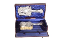 A CASED EDWARDIAN SILVER-MOUNTED HAND MIRROR AND BRUSH SET, BIRMINGHAM 1904