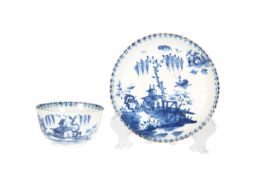 AN EARLY LOWESTOFT BLUE AND WHITE TEA BOWL AND SAUCER, c.1765