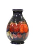 A WILLIAM MOORCROFT FLAMBE POTTERY VASE