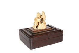 A JAPANESE HARDWOOD BOX MOUNTED WITH AN IVORY CARVING