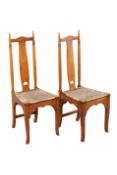 A PAIR OF SCOTTISH ARTS AND CRAFTS OAK AND RUSH SEATED SIDE CHAIRS